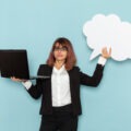 Professional woman holding a laptop beside a white bubble representing Gen Z communication and digital clarity
