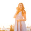 Young woman standing in soft morning light with a calm expression symbolising inner peace and emotional growth in her twenties