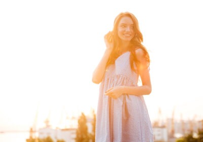Young woman standing in soft morning light with a calm expression symbolising inner peace and emotional growth in her twenties
