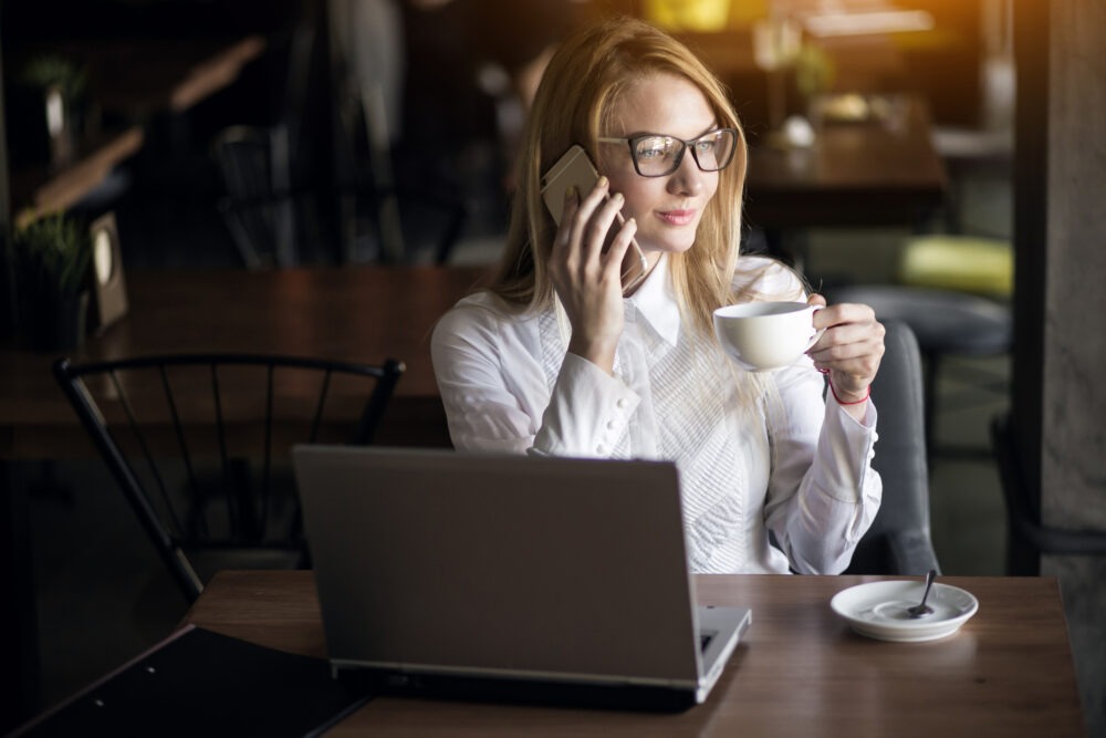 Confident woman sitting at desk with calm expression