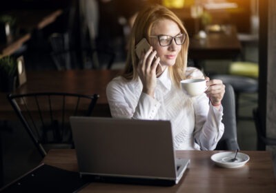 Confident woman sitting at desk with calm expression