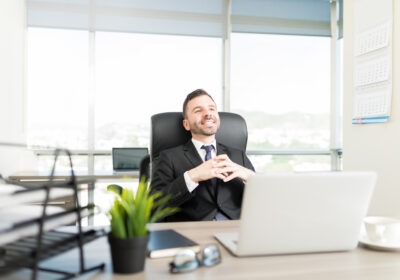 Calm business leader sitting at a desk in a modern office, focused and thoughtful in a quiet work environment