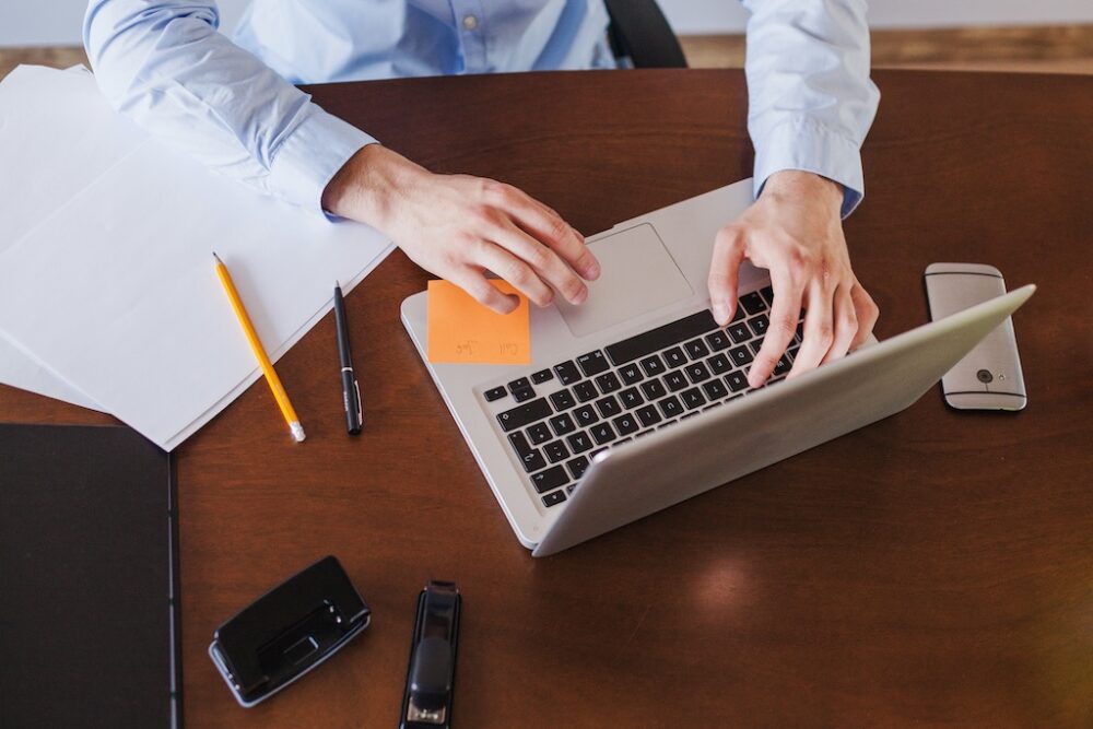 Professional focusing on tasks at a laptop in a calm office
