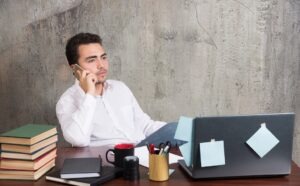 Professional at laptop looking thoughtful in a quiet office